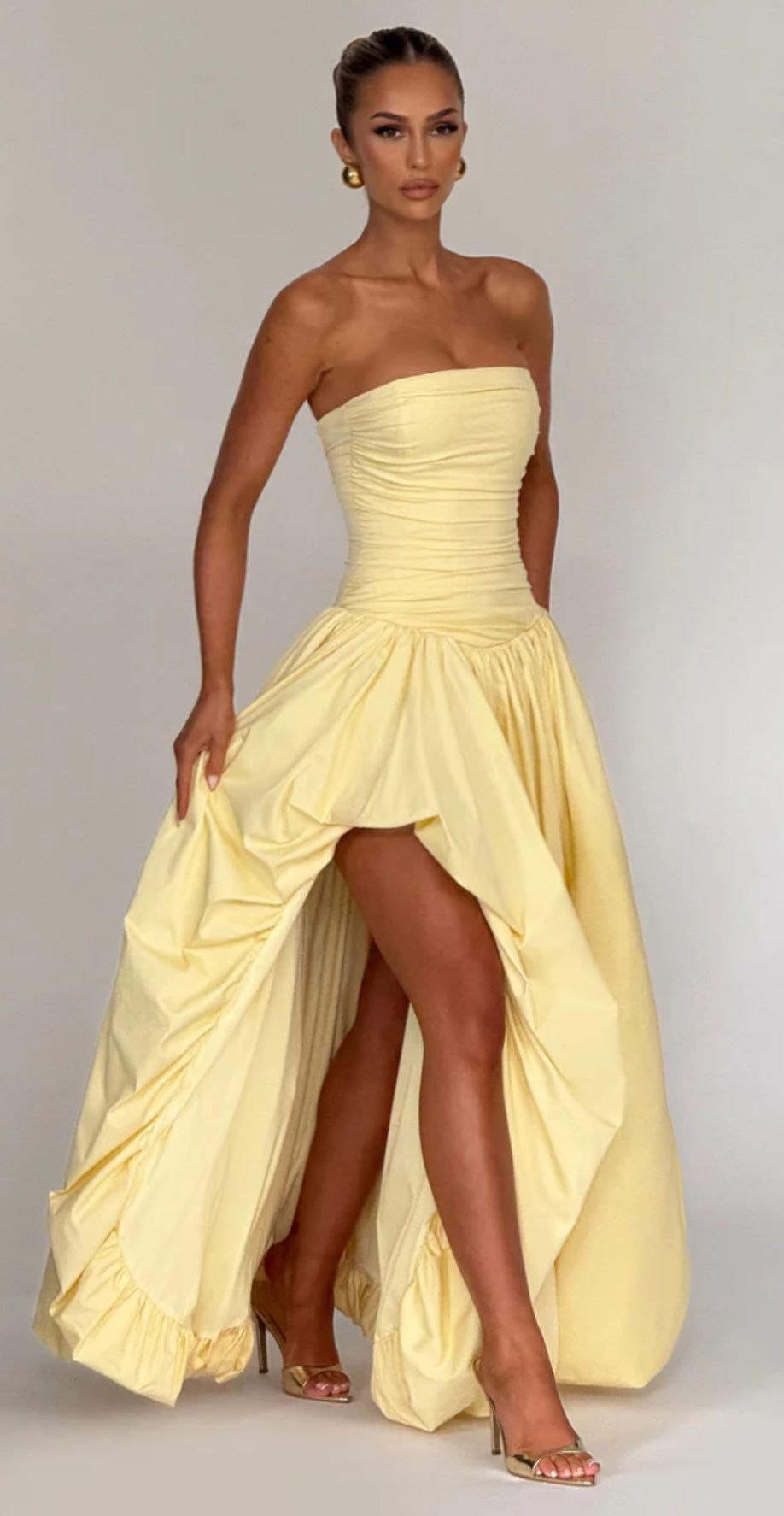 Babyboo Jillian Dress in Lemon side view shoing leg split to bubble maxi skirt.