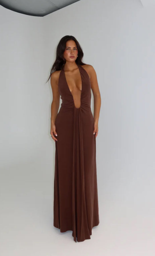 Woman wearing a brown halter neck Misah Jennifer Cupro dress on a white background