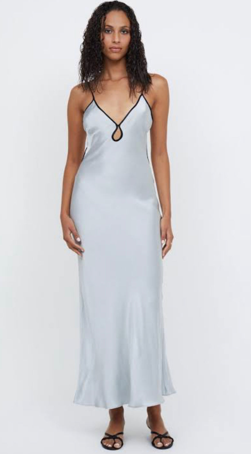 Bec & Bridge Cedar City Maxi Dress in Silver with Black edging, front view model with long dark curly hair on white background.