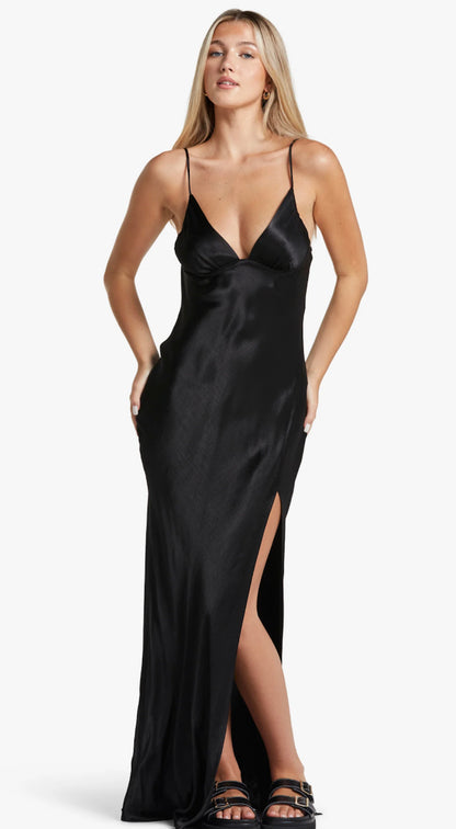 Bec & Bridge Ren Spilt Maxi dress in black. Model with blonde hair and white background