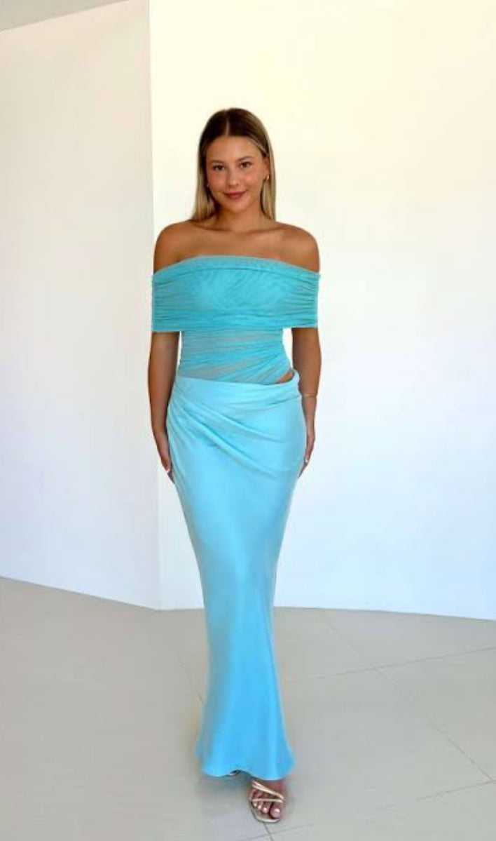 Woman wearing a light blue off-shoulder Benni Nico dress against a white background