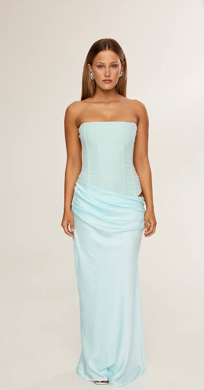 Woman wearing a Hntr the Label Huxley Aqua strapless gown against a plain background