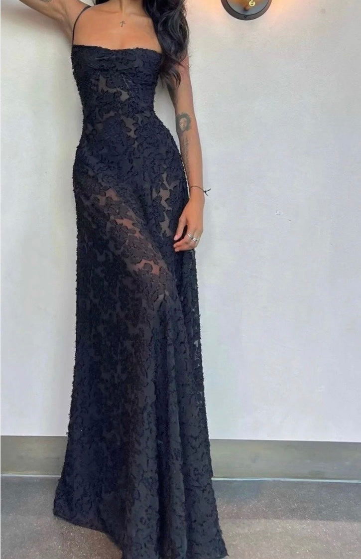 Black lace House of CB seren evening gown on a plain background