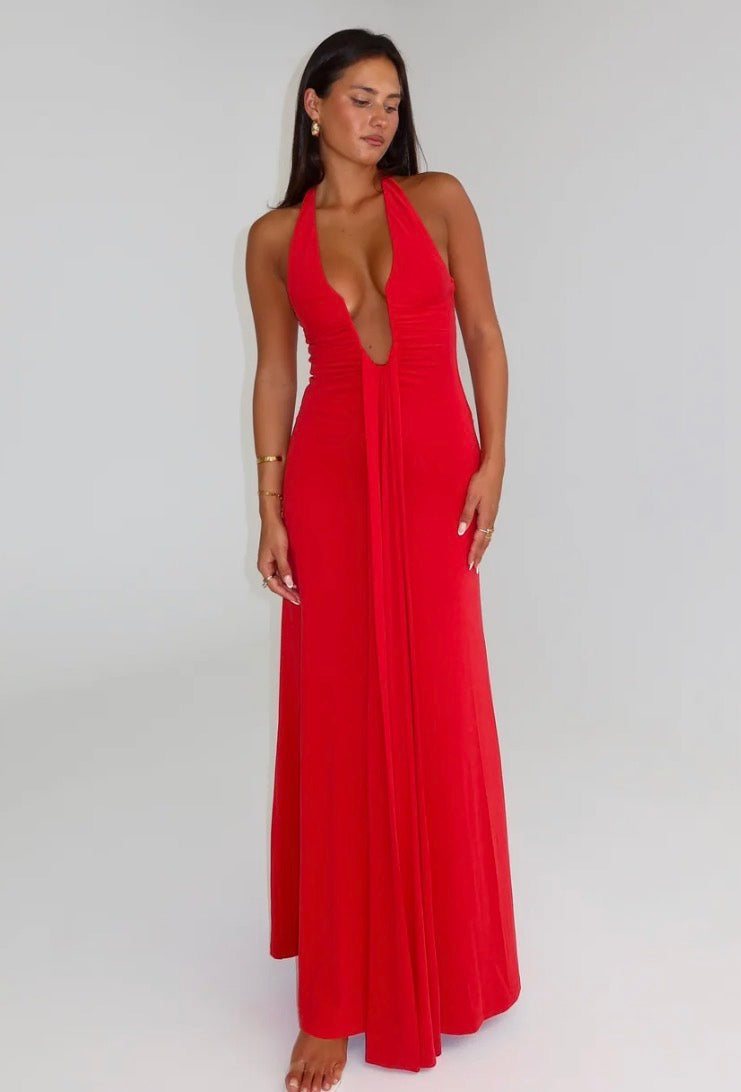Woman wearing a red halter neck dress on a white background by Misha. Jennifer Cupro Red Maxi dress. 