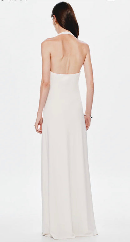 Image shows a model facing away from the camera showing the back of the white Misha Jennifer Cupronickel gown on a white background