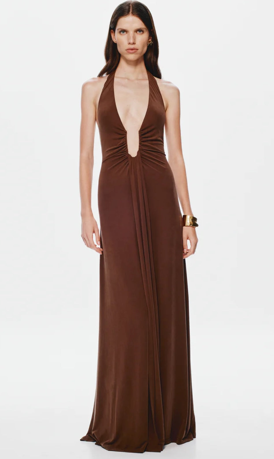 Woman wearing a brown halter neck Misha Jennifer Cupro gown on a white background
