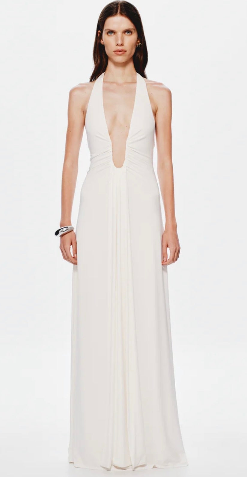 Woman wearing a white halter neck gown on a white background