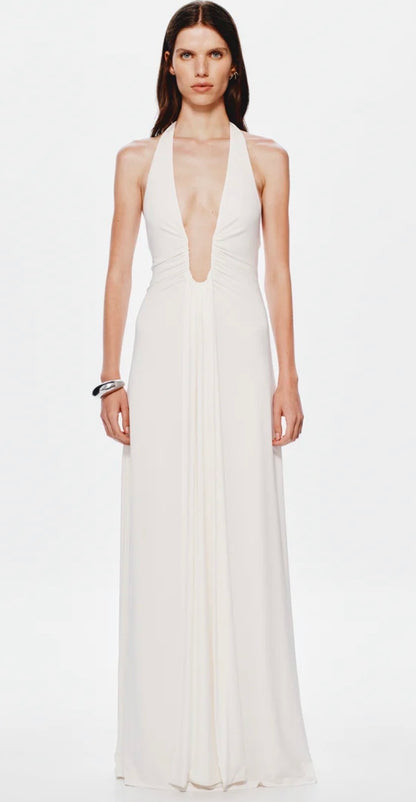 Woman wearing a white halter neck gown on a white background