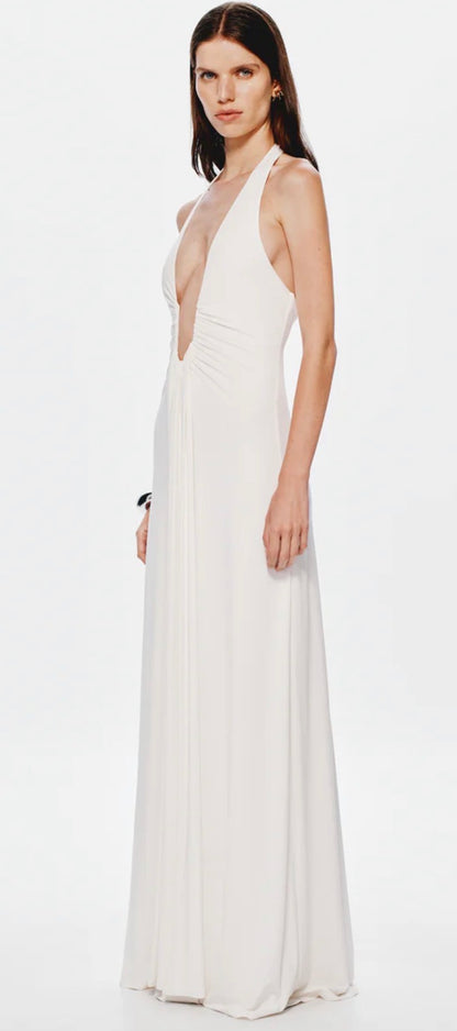 Woman wearing a white Misha Jennifer Cupro evening gown on a white background