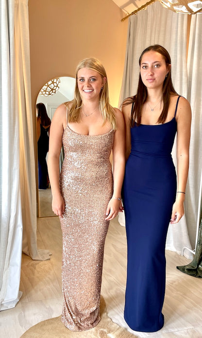 Two models wearing Nookie Bailey Gown in Navy with Nookie Lovers Gown in Rose Gold. Ball dresses available to rent, Auckland.