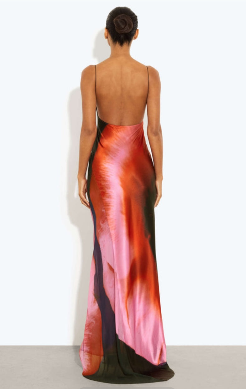 Rat & Boa Solaris Dress back view. Image shows woman wearing a colorful dress with a gradient design on a white background