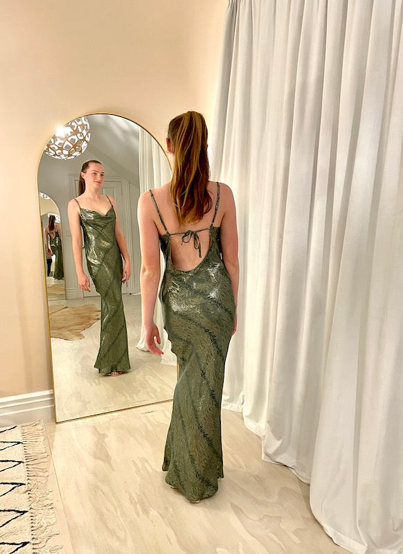 Rat & Boa Alessandra Slip dress in metallic green, back view model in rental studio. 