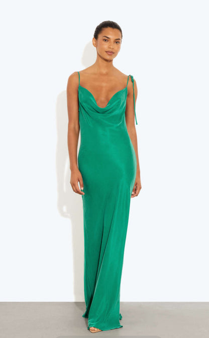 Woman wearing a Rat and Boa Ophelia green evening gown against a white background