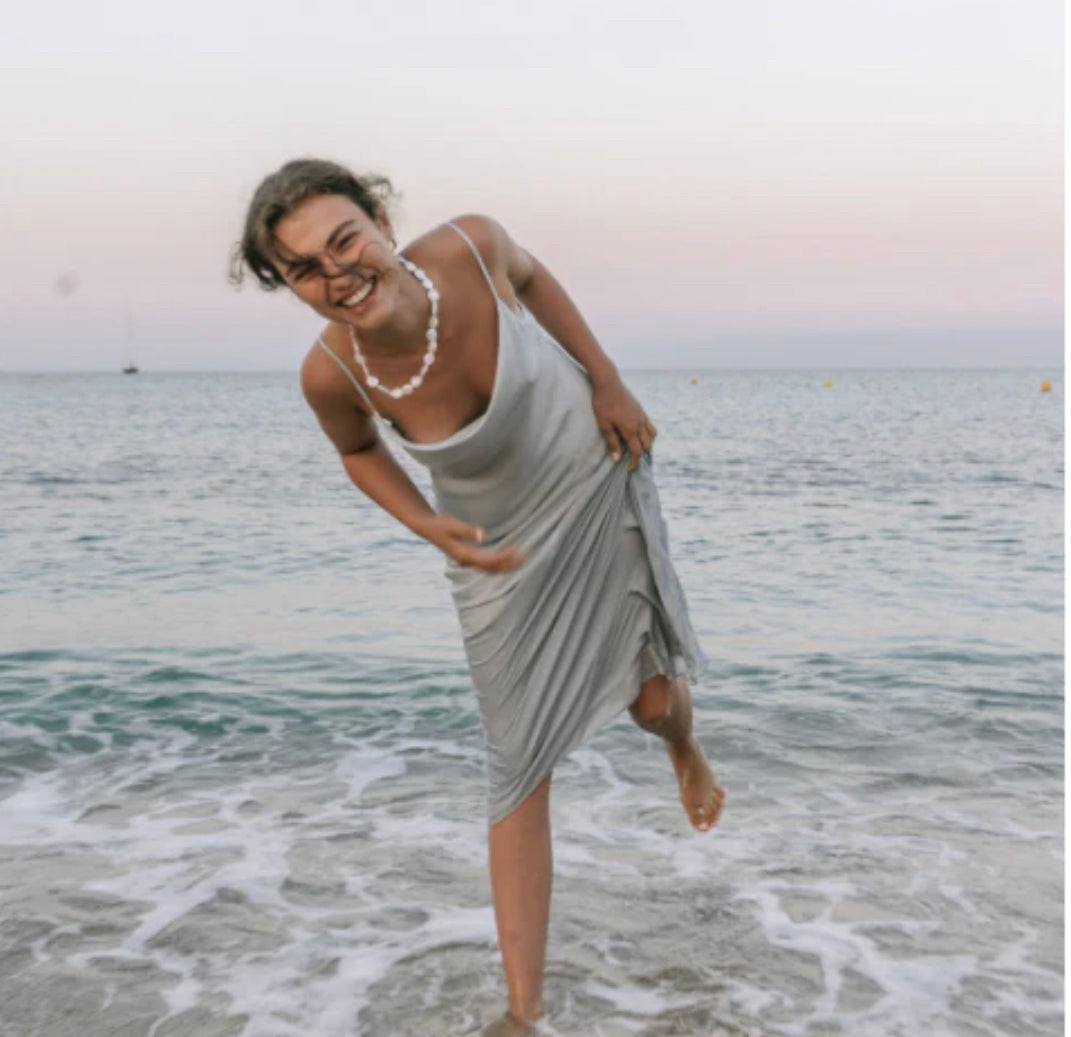 Shona Joy Luxe Bias Slip Dress in cloud blue model standing in sea