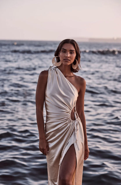 Sonya Nour Gown in Ocean Pearl. Model shown in front of the ocean at dusk. 