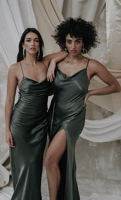 Shona Joy La Lune Lace Back Maxi Dress in Olive next to another model wiearing Shona Joy La Lune dress in Olive with a cream draped fabric background